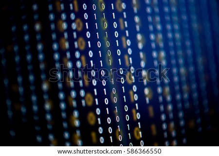 Digital binary data on computer screen, selective focus.