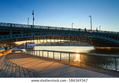 Bridge, Pont de Universite, over the Rhone river in Lyon on a sunny afternoon. Royalty-Free Stock Photo #586369367