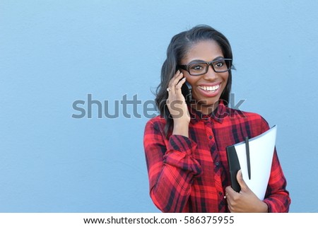 Portrait, young, happy beautiful woman in plaid shirt speaking on cell phone, isolated on blue background. Good news space for text