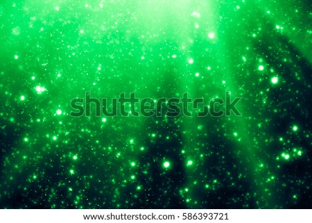 Green abstract background. Bokeh or round defocused particles or glitter lights