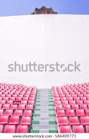 Outdoor Empty white billboard screen for advertising in stadium with seats rows and blue sky background
