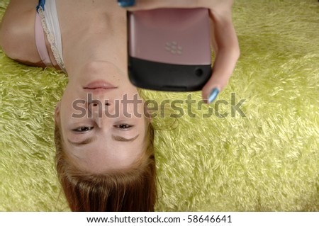 Teenage girl checks her text messages on her mobile phone.