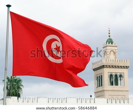 Red flag, clouds and minaret in Tunisia Royalty-Free Stock Photo #58646884