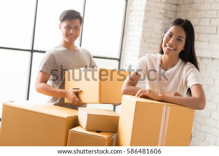 Couple helping pack the goods ordered online customers.