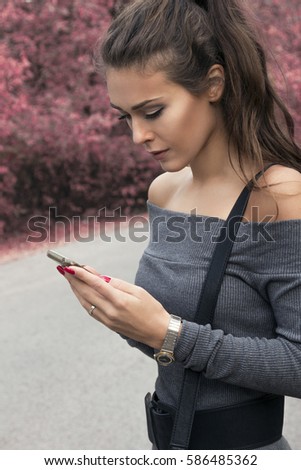 Beautiful girl sending messages on her phone