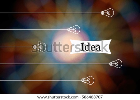 Light bulb hanging from the top with inscription IDEA on a colorful background bokeh lights led. Information concept, creative, technology and innovation. Image has Shallow DOF or grain or blurry.
