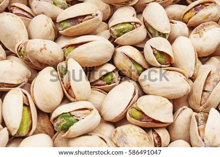 
Pistachio texture. Nuts. Green fresh pistachios as texture. Roasted salted pistachio nuts healthy delicious food studio photo.