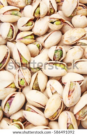 
Pistachio texture. Nuts. Green fresh pistachios as texture. Roasted salted pistachio nuts healthy delicious food studio photo.