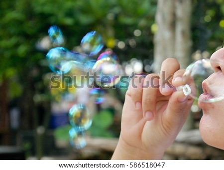His brother, blowing bubbles