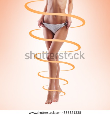 Close-up of thin and beautiful female body. Weight loss, sports, exercising, tan, sun burn concept.