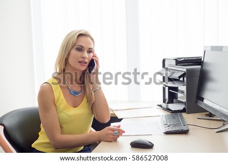 Business woman talking on the phone in the office