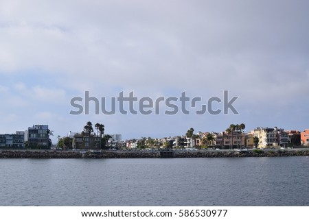 Sunny and cloudy day, houses and palm trees in bay area, California  Royalty-Free Stock Photo #586530977