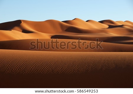 Sand dunes in Sahara desert, Libya Royalty-Free Stock Photo #586549253