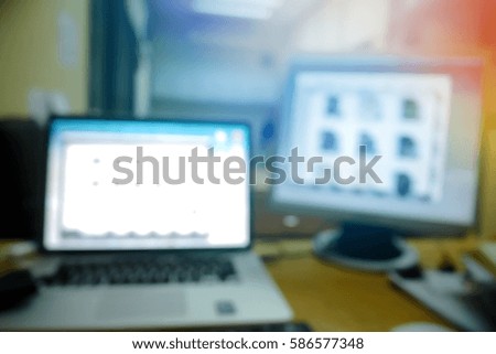 Picture blurred  for background abstract and can be illustration to article of Computer and laptop on the working place in the office