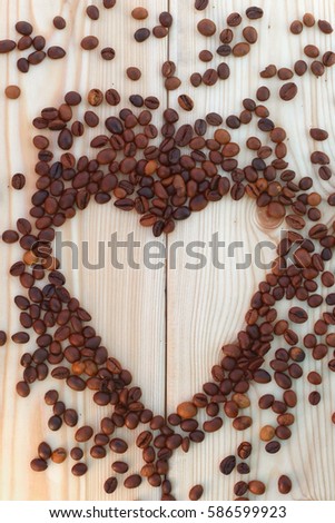 Coffee beans on the board in the form of heart