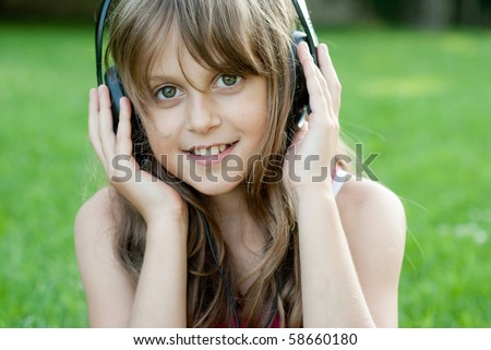 Girl listen music with headphones in the park