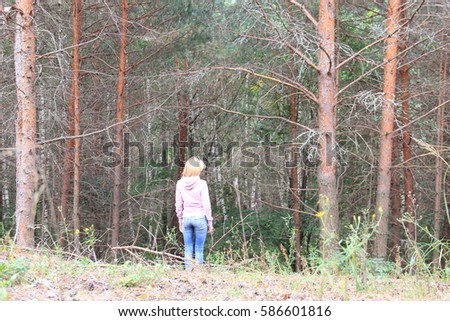 Girl walks in the green forest