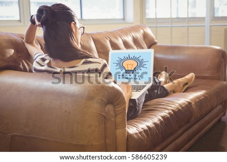 Print against business woman posing in front of her computer with her card