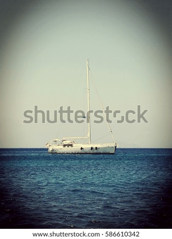 Sailboat floating in the calm Mediterranean Sea,