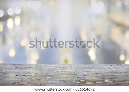 image of wooden table in front of abstract blurred background 