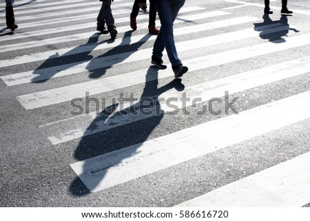 Blurry people and their shadows on crossing   Royalty-Free Stock Photo #586616720