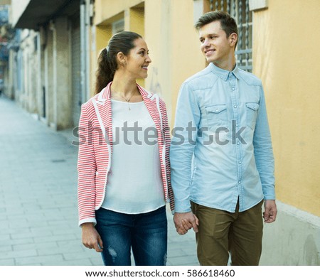 Young  couple posing at city street in spring day