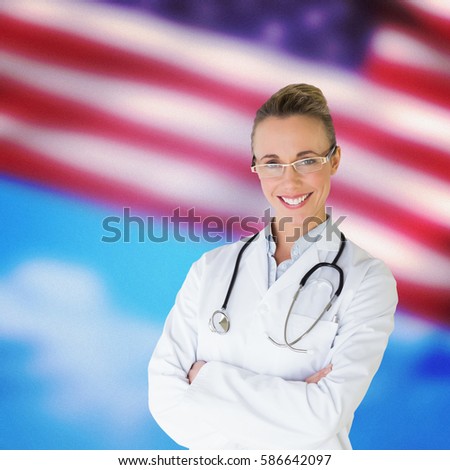 Beautiful female doctor with arms crossed in hospital against composite image of close-up of american flag