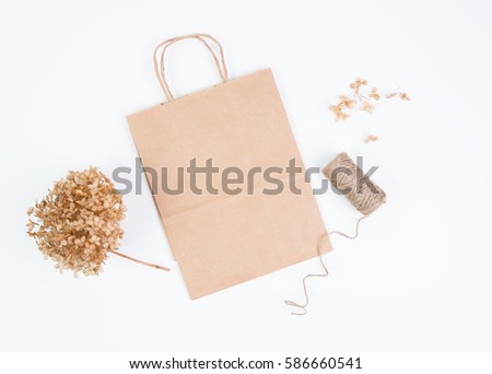 Brown paper bag mock up with dried hydrangea flowers and twine