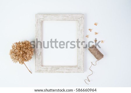 Empty white rustic picture frame with dried hydrangea flowers and twin