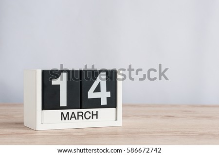 March 14th. Day 14 of month, wooden calendar on light background. Spring time. Commonwealth and International pi days