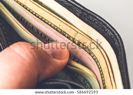 Man opens the purse with money, cash dollar bills. Macro photo