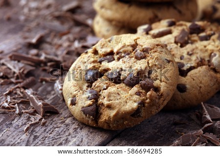 Chocolate cookies on wooden table. Chocolate chip cookies shot Royalty-Free Stock Photo #586694285