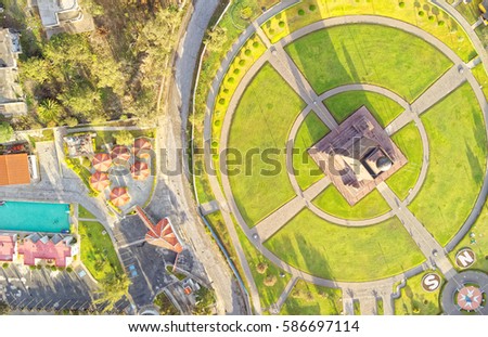 Capture the breathtaking beauty of Mitad del Mundo monument in Quito,Ecuador,with a stunning aerial still image bathed in the morning light.