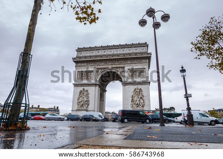 Triumphal arch. Arc de triomphe. View of Place Charles de Gaulle. Famous touristic architecture landmark in rainy day. Long exposure photography. Paris. France.