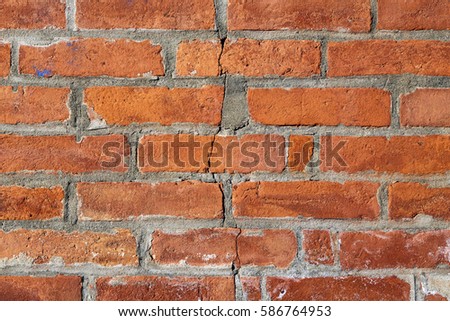 Close Up of an Exterior Orange Brick Wall with a Crack