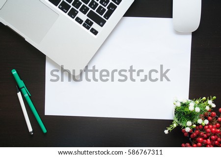 Work Desk table with notebook, paper and plant with flowers. Top view with copy space