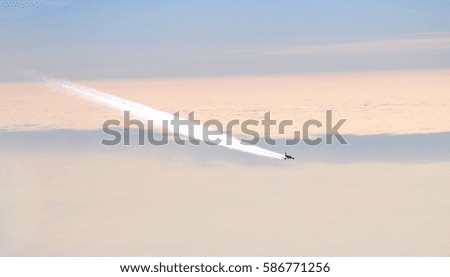 Passenger plane flying by, pictured from above 