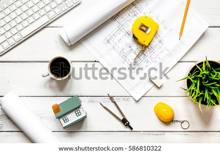 engineering tools on wooden table with drawings apartments top v