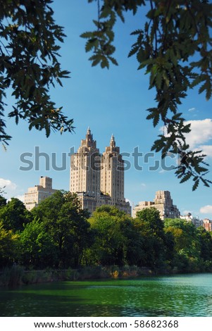 Central park in New York City Manhattan with trees and skyscrapers with lake reflection	