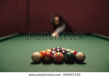American billiard poule. Shot of a man playing billiard. Triangle of billiard balls. 
