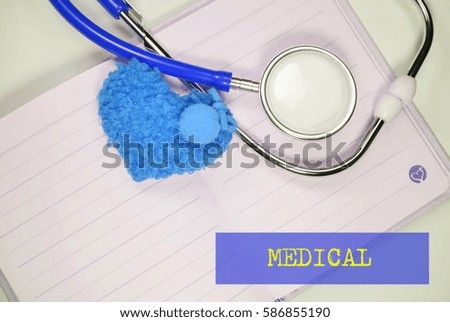 Stethoscope and heart shape on an open book on a white background. Medical, Healthcare and Wellness concept.