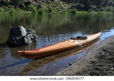 wooden strip built kayak on river