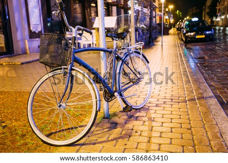 Single Bicycle Bike Parking On Street In Old Part European Town In Summer Evening Night.