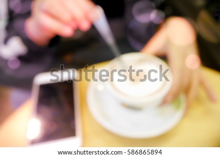 Picture blurred  for background abstract and can be illustration to article of woman with coffee and smartphone