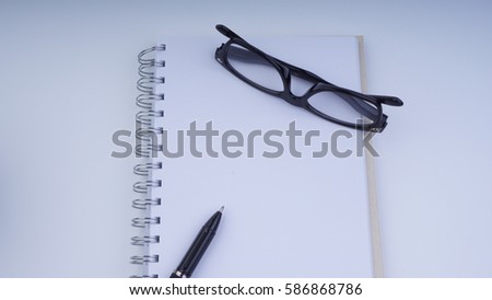 Conceptual image of business concept with vase, book,pen and glasses with copy space on white background. Selective focus.
