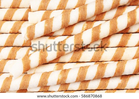 Ice cream wafer sticks as background. Wafer biscuit swirled stick texture. Wafers pattern.