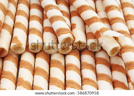 Ice cream wafer sticks as background. Wafer biscuit swirled stick texture. Wafers pattern.