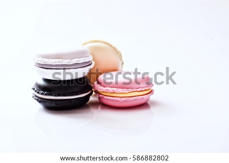 Cake macaron or macaroon on turquoise background from above, colorful almond cookies, pastel colors, vintage card, top view.