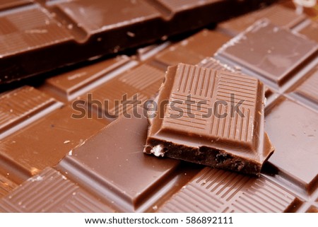 
Chocolate bars as background. Milk and dark shiny chocolate texture. Stack chocolates pattern. Stunning beautiful cacao brown dessert sweets. 
 