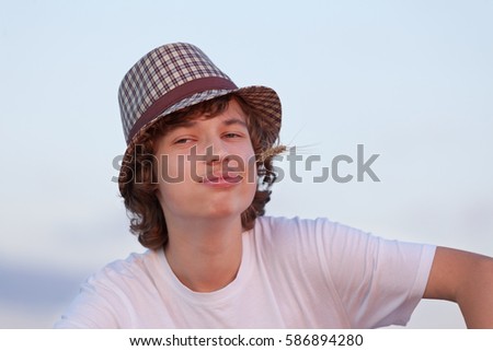 happy boy in hat in the field in spring